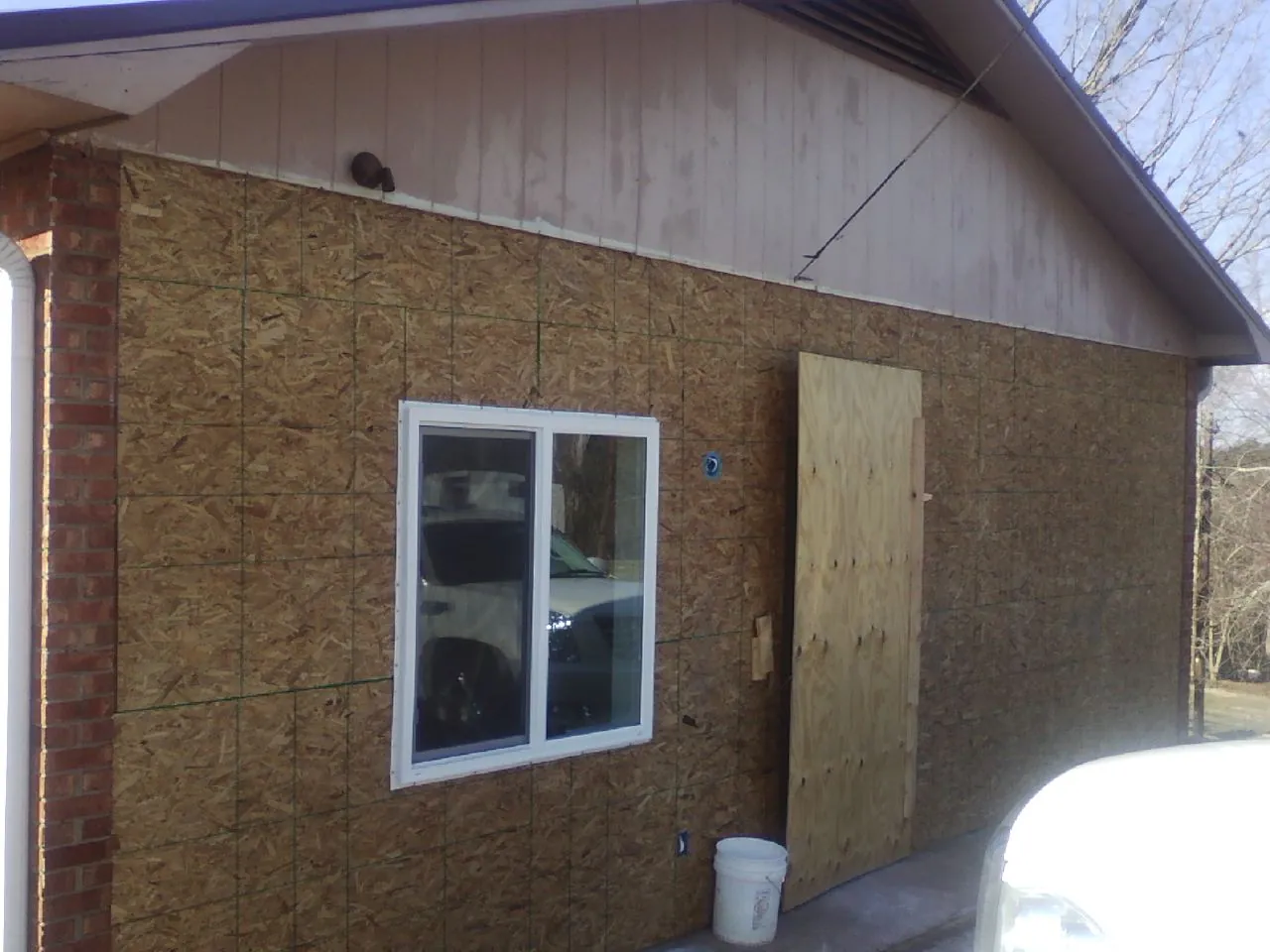 OSB sheathing on a garage addition wall before siding in Roslyn